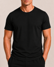 Male model wearing a blank black OVRSAID regular slim-fit T-shirt, front view
