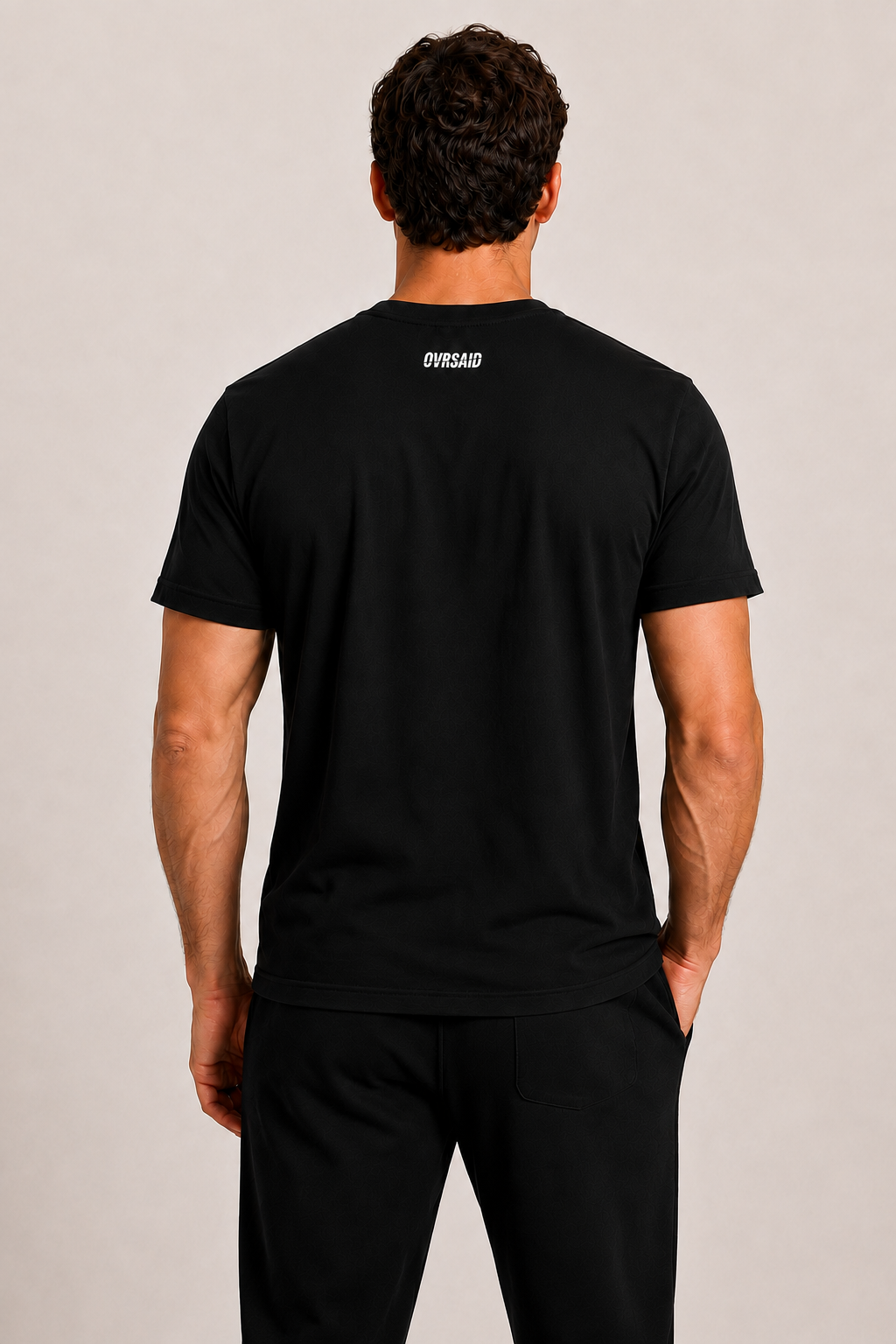 Back view of OVRSAID black statement tee with small OVRSAID neck logo