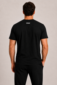 Color Black — Back view of male model wearing OVRSAID tee with white back-neck wordmark