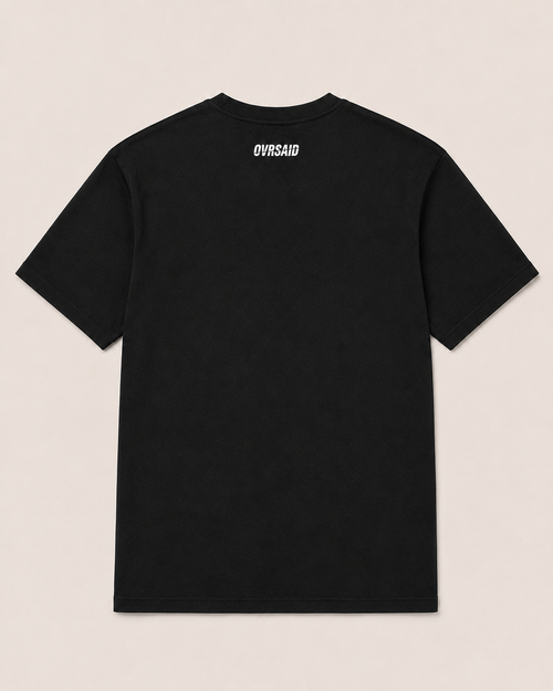 Close-up of OVRSAID I HAVE EXPENSIVE TASTE AND QUESTIONABLE INCOME front print on black statement tee