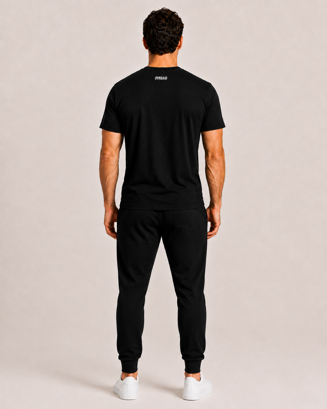 Back view of OVRSAID black statement tee with small OVRSAID neck logo