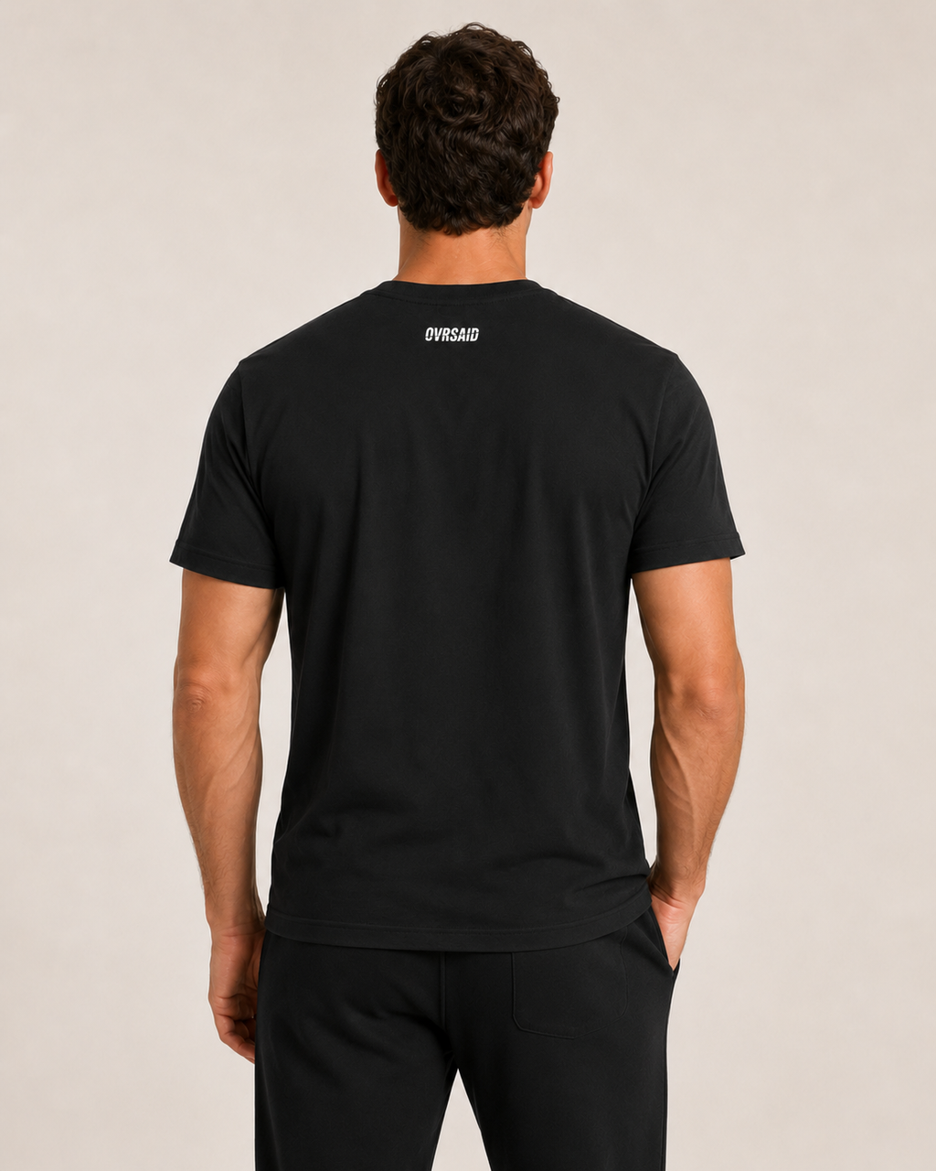 Back view of OVRSAID black statement tee with small OVRSAID neck logo