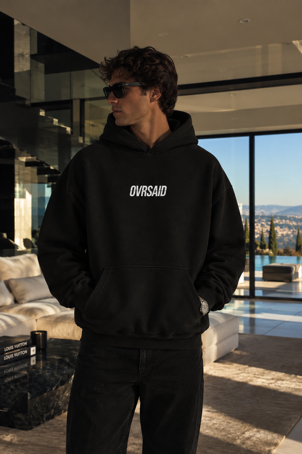 Color Black — OVRSAID MY LIFESTYLE NEEDS INVESTORS. oversized hoodie on male model, front view with small OVRSAID chest mark