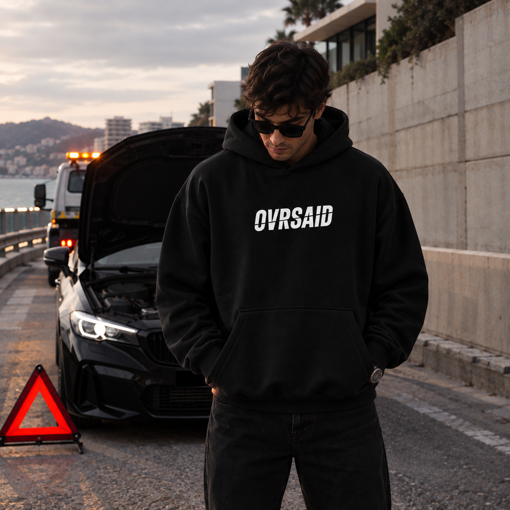 Color Black — OVRSAID BE REALISTIC: EXPECT A MIRACLE. oversized hoodie on male model, front view with small OVRSAID chest mark