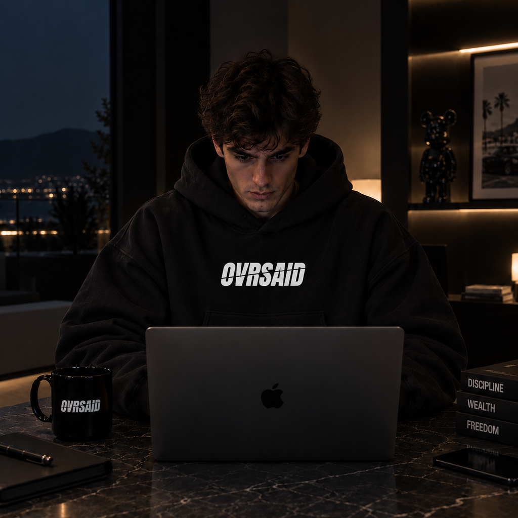Color Black — OVRSAID I MAKE CHATGPT LOOK LIKE AN INTERN. oversized hoodie on male model, front view with small OVRSAID chest mark