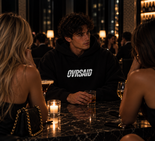 Color Black — OVRSAID DON'T STUDY ME. YOU WON'T GRADUATE. oversized hoodie on male model, front view with small OVRSAID chest mark