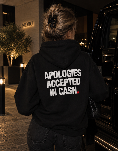 Color Black — OVRSAID APOLOGIES ACCEPTED IN CASH. oversized hoodie on female model, back view showing the white back print