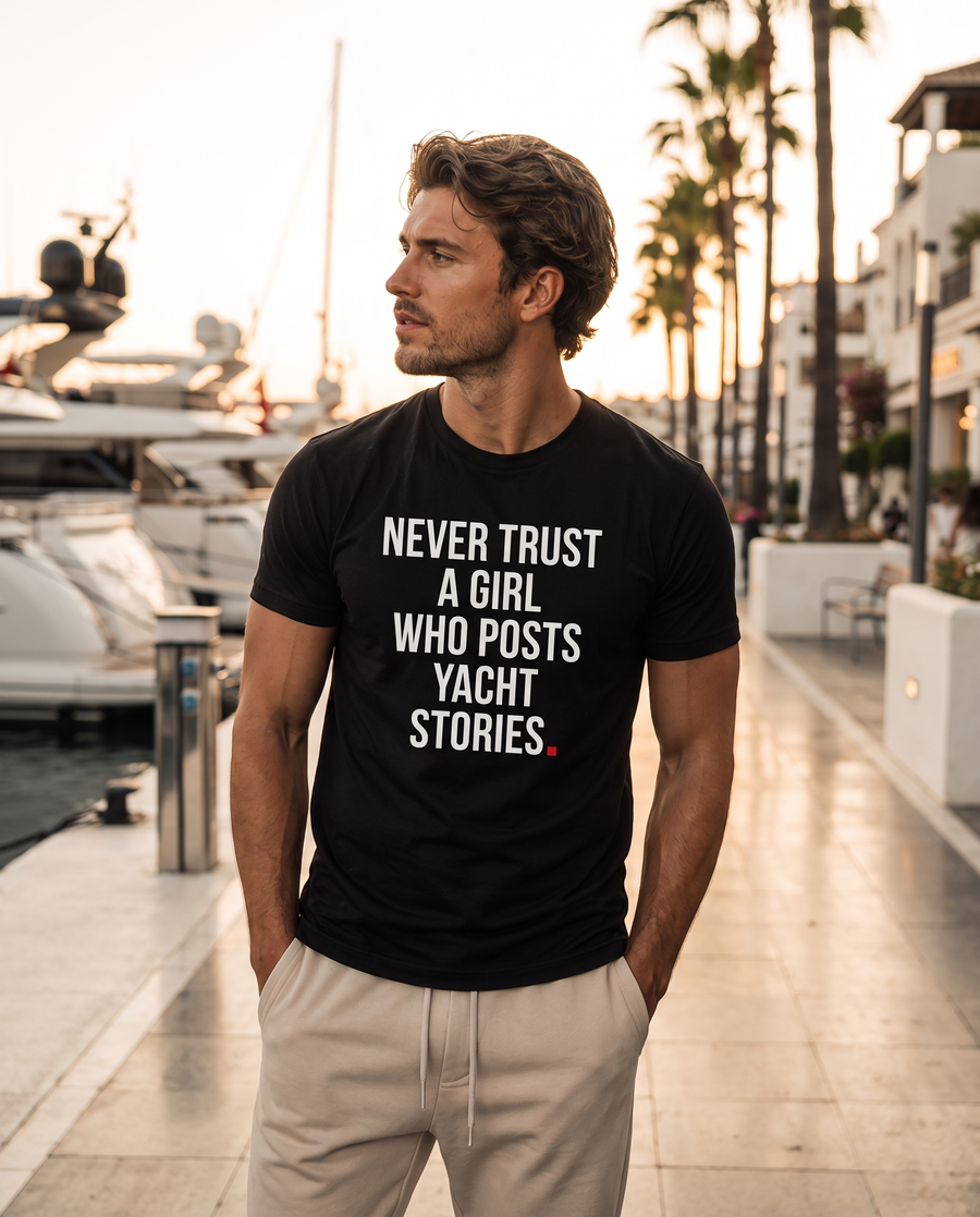 Color Black — OVRSAID NEVER TRUST A GIRL WHO POSTS YACHT STORIES tee on male model, front view